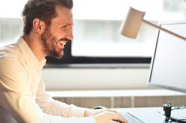 man searching computer for internship opportunities
