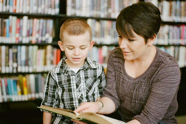 Woman teaching a small child