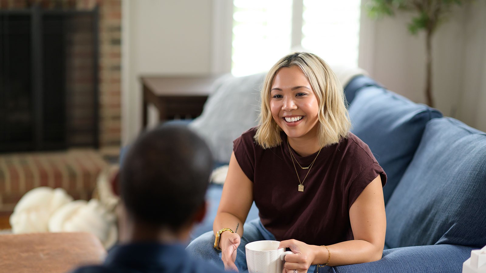 student drinking coffee on couch